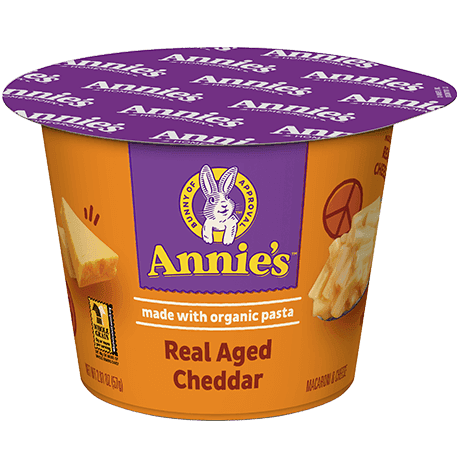 Annie's Real Aged Cheddar microwaveable mac and cheese cup, made with organic pasta, front of cup.