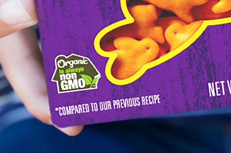 Close up of a box of Annie's crackers, showing the "Organic is always non GMO" seal.