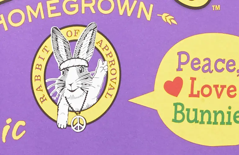 An illustrated bunny, wearing a headband and peace symbol necklace. It is holding up two fingers in a peace sign. A speech bubble reads "Peace, Love, Bunnies".