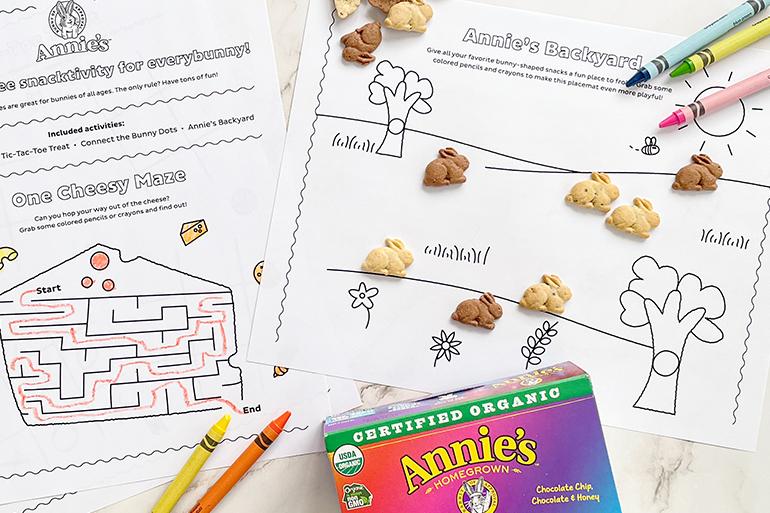 A zoomed in view of two Annie's Activity Sheets arranged with Bunny Grahams and crayons.
