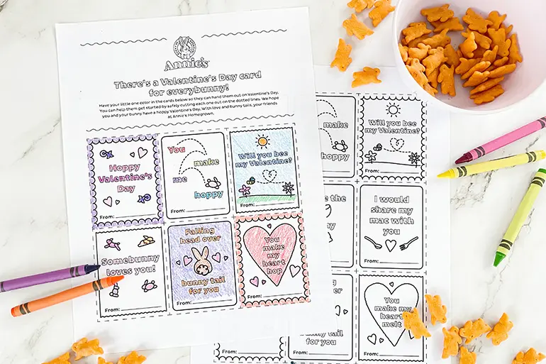 Annie's "There's a Valentine's Day card for every bunny" coloring activity sheet with single Cheddar Bunnies and crayons laying on a marble slab.