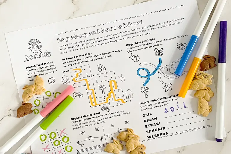 "Hop along and learn with us" activity sheet showing several games and Bunny Grahams and markers lying around.