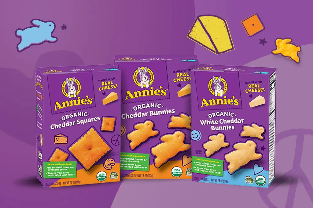 Single boxes of Annie's Organic Cheddar Squares, Annie's Organic Cheddar Bunnies and Annie's Organic White Cheddar Bunnies with a purple background.