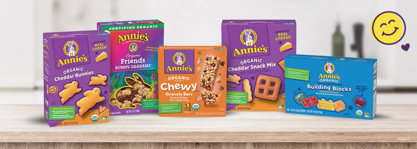 Boxes of Annie's Organic Cheddar Bunnies, Annie's Organic Bunny Grahams, Annie's Organic Chewy Granola Bars, Annie's Organic Snack Mix and Annie's Organic Fruit Snacks sitting on a kitchen counter.