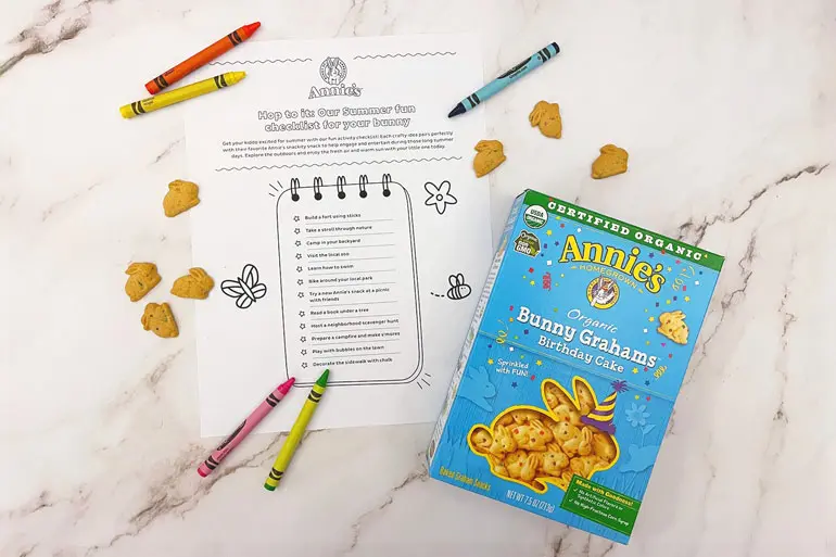 "Annies Hop to it's our summer fun checklist for your bunny" activity sheet with a box of Birthday Cake bunny grahams and crayons.