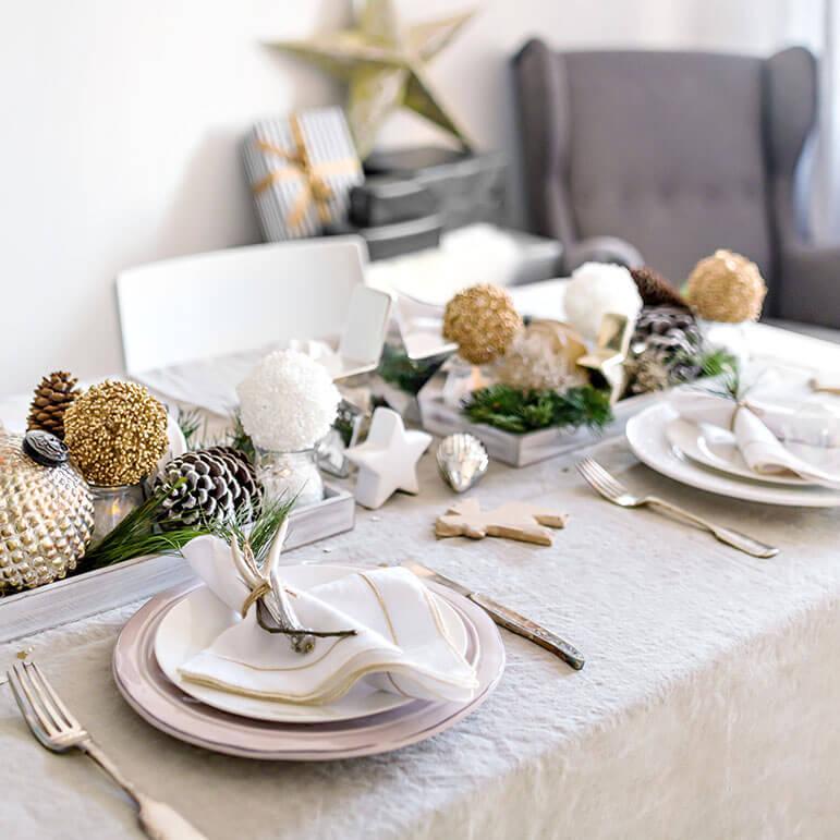 A beautiful table setting with white and gold decorations