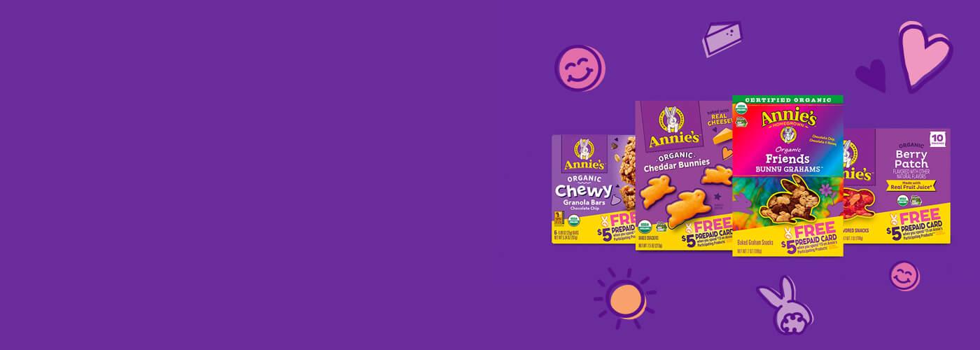 A purple background with a variety of front of packs of snacks on it such as Annie's Bunny Grahams, Annie's Cheddar Bunnies, Annie's Chewy Granola Bars and Annie's Fruit Snacks.