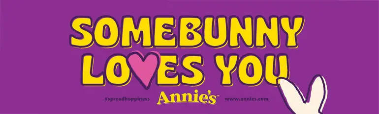Purple rectangle sticker with a heart, bunny ears, the text: "Somebunny Loves You", and the Annie's logo.